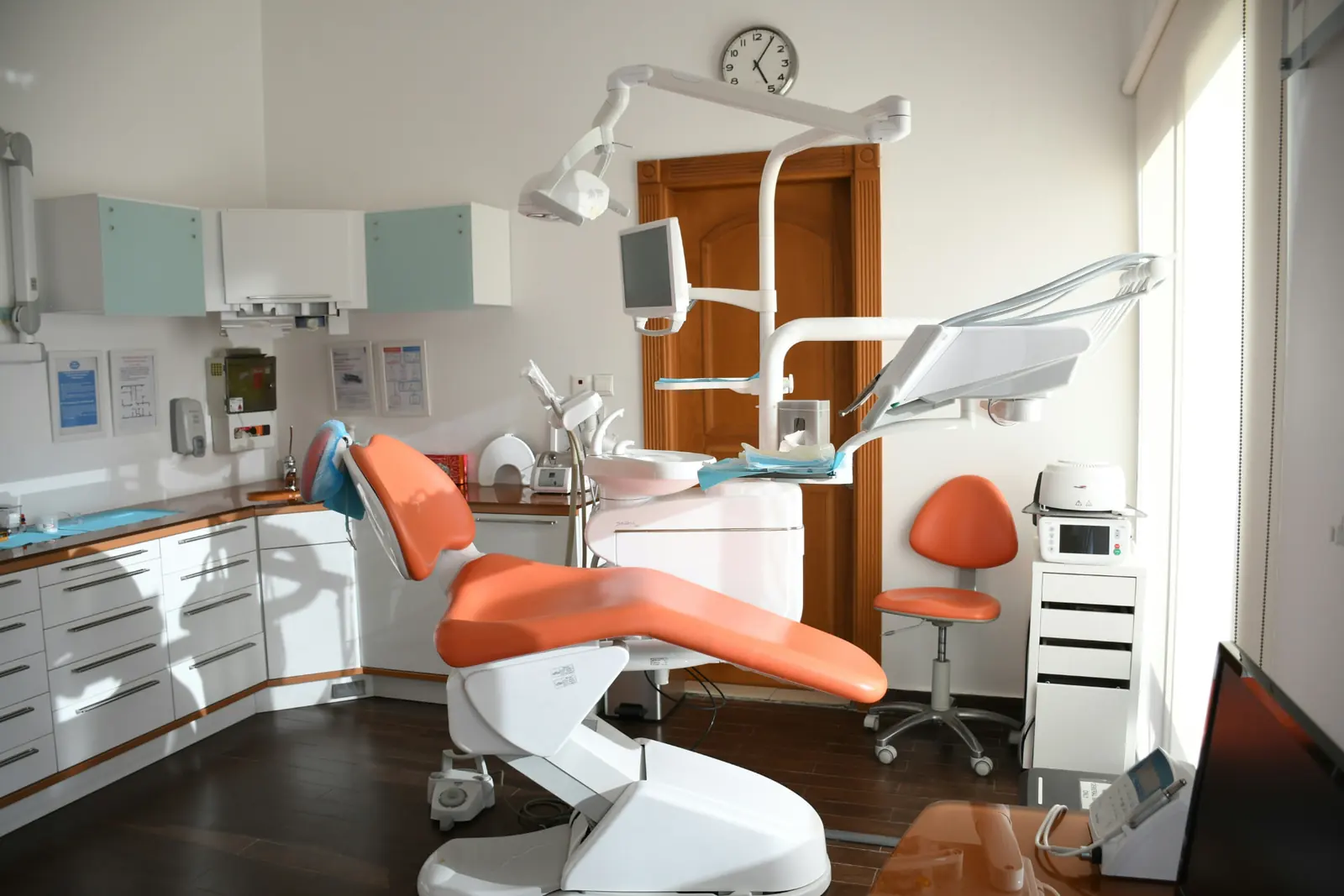 Modern dental exam room with patient chair and equipment