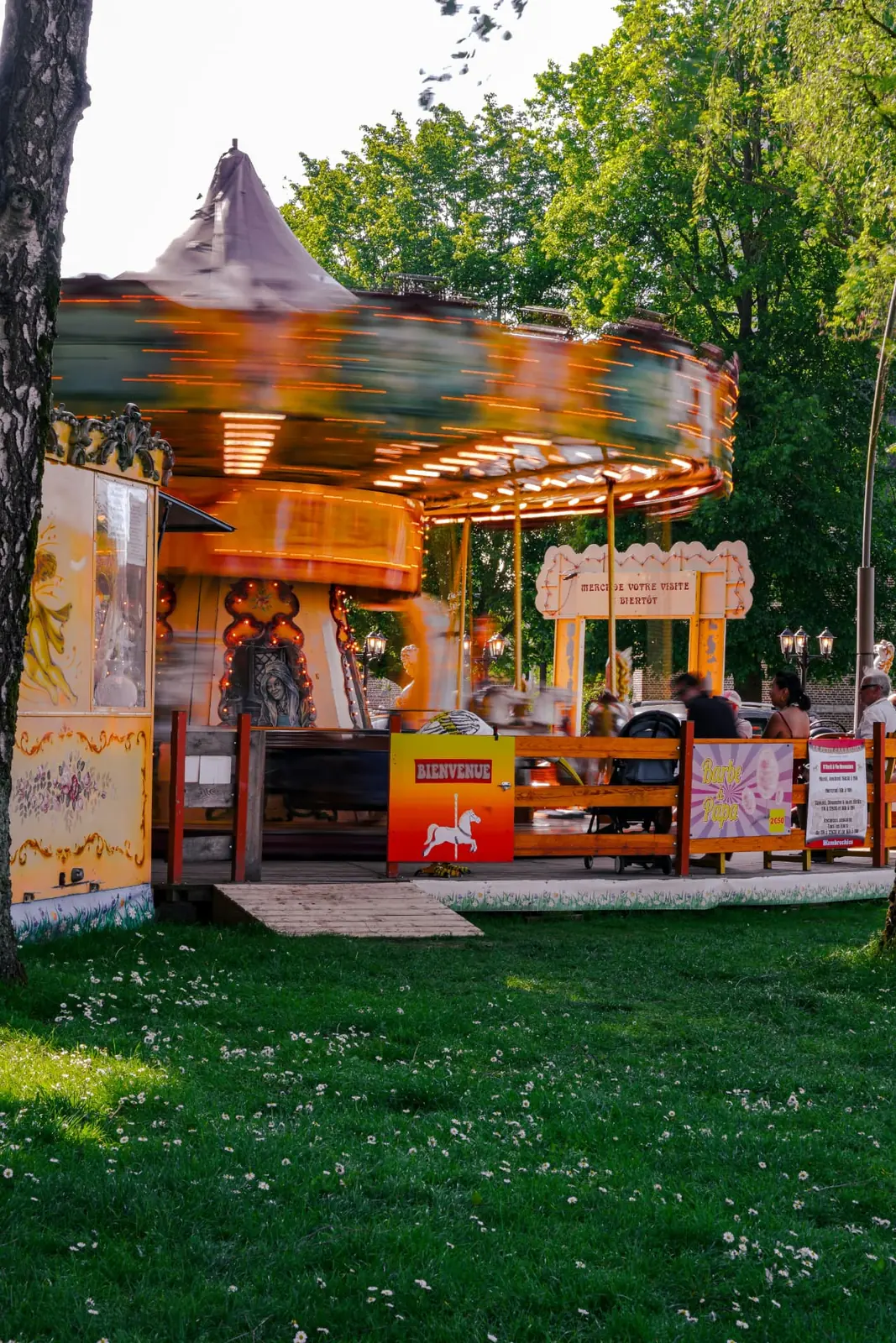 Classic spinning carousel in a park at golden hour